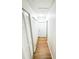 Bright hallway with wood-look floors, white walls and white closet doors for ample storage at 13018 Clay Ave, Largo, FL 33773
