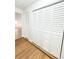 Hallway with wood-look floors and large white closets featuring shutter-style doors at 13018 Clay Ave, Largo, FL 33773