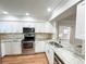 Bright kitchen features granite countertops, stainless steel appliances, and white cabinetry at 13018 Clay Ave, Largo, FL 33773