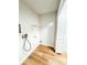 A dedicated laundry space with wood-look floors, shelving and hookups at 13018 Clay Ave, Largo, FL 33773