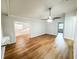 Open living space featuring sleek floors, neutral walls, crown molding, and ceiling fan at 13018 Clay Ave, Largo, FL 33773