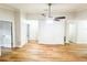 Open living space features ceiling fan, new floors, and access to multiple rooms at 13018 Clay Ave, Largo, FL 33773