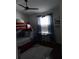 Bedroom featuring a wooden bunk bed, window and ceiling fan at 13020 Lorna Pl, Tampa, FL 33618