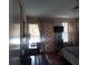 Comfortable bedroom featuring a desk, TV, and decorative curtains at 13020 Lorna Pl, Tampa, FL 33618
