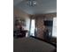 Bright bedroom featuring a desk, outdoor access, and a stylish chandelier at 13020 Lorna Pl, Tampa, FL 33618