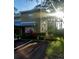 Charming townhome featuring lush landscaping, covered entrance, and well-maintained exterior at 13020 Lorna Pl, Tampa, FL 33618