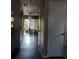 Long hallway leads to a bright living space with hardwood floors and natural light at 13020 Lorna Pl, Tampa, FL 33618