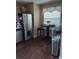 Functional kitchen area with stainless steel refrigerator and a cozy breakfast table and chairs at 13020 Lorna Pl, Tampa, FL 33618
