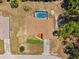 An aerial view reveals a home with screened pool, surrounded by lush greenery and neighborhood at 13040 Hanley Dr, Spring Hill, FL 34609