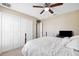 Bright bedroom featuring a comfortable bed, closet space, and a ceiling fan at 13040 Hanley Dr, Spring Hill, FL 34609