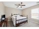 Cozy bedroom featuring soft carpet, a ceiling fan, and classic wood furniture at 13040 Hanley Dr, Spring Hill, FL 34609