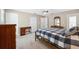 Spacious bedroom with soft carpet, a ceiling fan, and classic wood furniture at 13040 Hanley Dr, Spring Hill, FL 34609