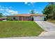 Charming single-story home with a well-manicured lawn and attached two-car garage at 13040 Hanley Dr, Spring Hill, FL 34609