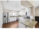 Modern kitchen with stainless steel appliances, granite counters, and ample cabinet space at 13040 Hanley Dr, Spring Hill, FL 34609