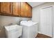 Functional laundry room with washer, dryer, storage cabinets and a utility sink at 13040 Hanley Dr, Spring Hill, FL 34609