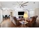 Open living room with wood floors, vaulted ceilings, seating and a large screen television at 13040 Hanley Dr, Spring Hill, FL 34609
