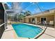 A pristine screened-in pool and deck in backyard creates a private outdoor oasis at 13040 Hanley Dr, Spring Hill, FL 34609