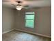 Neutral bedroom featuring a ceiling fan and a window with natural light at 1339 White Fox Run, Lutz, FL 33549