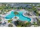 Aerial view of a resort style community pool with lounge chairs, umbrellas, and lush landscaping at 14727 Eagle Branch Dr, Nokomis, FL 34275
