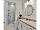 Bathroom showcasing a glass-enclosed shower and white vanity with modern fixtures and marble floor tiling at 14727 Eagle Branch Dr, Nokomis, FL 34275