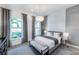 Bedroom featuring a large window view and decorative light fixture with elegant neutral decor at 14727 Eagle Branch Dr, Nokomis, FL 34275