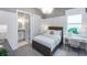 Bright bedroom featuring an ensuite bathroom, a decorative chandelier, and light neutral decor at 14727 Eagle Branch Dr, Nokomis, FL 34275