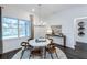 Bright dining area with a modern chandelier, round table, and large window providing ample natural light at 14727 Eagle Branch Dr, Nokomis, FL 34275