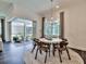 Elegant dining area with a view of the outdoor patio, a modern chandelier, and seating for six at 14727 Eagle Branch Dr, Nokomis, FL 34275