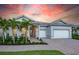 Charming single-Gathering home with a three-car garage, beautiful landscaping, and a brick-paved driveway at 14727 Eagle Branch Dr, Nokomis, FL 34275