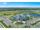 Beautiful exterior view of the community center, pool, and tennis courts at 14727 Eagle Branch Dr, Nokomis, FL 34275