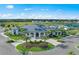 Stunning exterior view of the clubhouse with lush landscaping and ample parking at 14727 Eagle Branch Dr, Nokomis, FL 34275