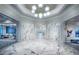 Stunning hallway with marble accents, decorative lighting, and access to beautifully decorated rooms at 14727 Eagle Branch Dr, Nokomis, FL 34275