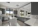 Modern kitchen featuring gray cabinets, granite countertops, stainless steel appliances, and a kitchen island at 14727 Eagle Branch Dr, Nokomis, FL 34275