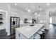 Spacious kitchen featuring a large center island, stainless steel appliances, and white cabinetry at 14727 Eagle Branch Dr, Nokomis, FL 34275