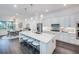 Bright kitchen with a large center island, white cabinetry, stainless steel appliances, and pendant lighting at 14727 Eagle Branch Dr, Nokomis, FL 34275