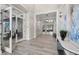 Elegant lobby showcasing herringbone floors, white trim and moldings, and access to common areas at 14727 Eagle Branch Dr, Nokomis, FL 34275