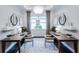 Bright home office space featuring two desks, matching chairs, and decorative light fixtures at 14727 Eagle Branch Dr, Nokomis, FL 34275
