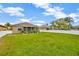 Large green backyard featuring a patio and privacy fence at 1535 Crossvine Ct, Trinity, FL 34655
