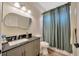 Bathroom features a modern vanity with black countertop, and an unusual mirror at 1535 Crossvine Ct, Trinity, FL 34655