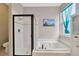 Bright bathroom featuring a shower, bathtub, and linen closet at 1535 Crossvine Ct, Trinity, FL 34655