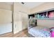 A cozy bedroom features built-in shelving, bunk beds, and a spacious closet at 1535 Crossvine Ct, Trinity, FL 34655