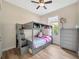 A cute bedroom shows bunk beds with storage and a dresser in a well lit space at 1535 Crossvine Ct, Trinity, FL 34655