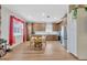 Bright dining area with a floral table setting and a window with sheer red curtains at 1535 Crossvine Ct, Trinity, FL 34655