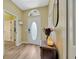 Inviting entryway featuring wood-look flooring and an oval glass accent in the front door for natural light at 1535 Crossvine Ct, Trinity, FL 34655