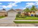 Charming single-story home featuring a well-manicured lawn, mature palm trees, and an attached two-car garage at 1535 Crossvine Ct, Trinity, FL 34655