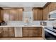 Kitchen with abundant cabinets, white countertop, stainless appliances, and wood flooring at 1535 Crossvine Ct, Trinity, FL 34655