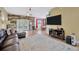 Open living room with a modern wood accent wall and a comfortable leather couch at 1535 Crossvine Ct, Trinity, FL 34655