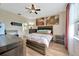Cozy main bedroom featuring a rustic wood bed frame and stylish decor at 1535 Crossvine Ct, Trinity, FL 34655