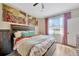 Bright main bedroom with artwork above the bed and a window at 1535 Crossvine Ct, Trinity, FL 34655