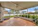 A screened in patio with room for plants and dog supplies at 1535 Crossvine Ct, Trinity, FL 34655